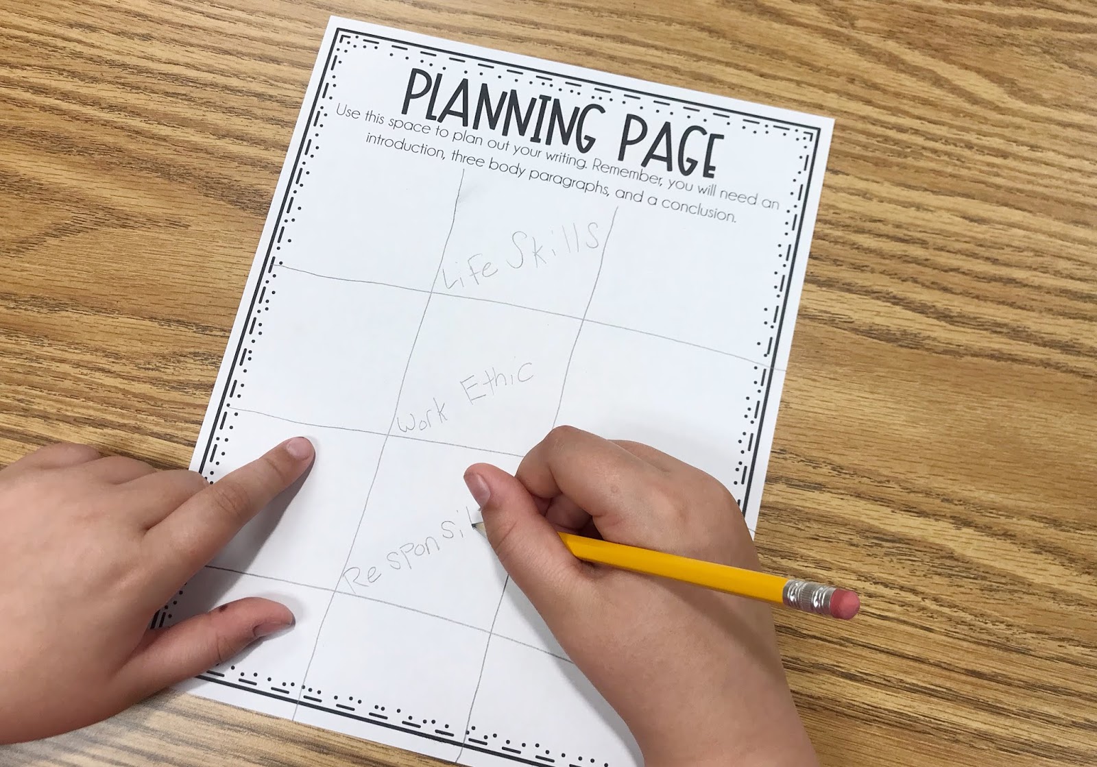 Student completing a Planning Page with their own graphic organizer drawn