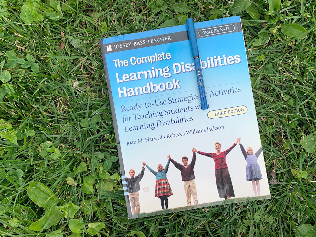 Image of a Book Titled "The Complete Learning Disabilities" Laying in the Grass with a Pen on Top of the Book as the Third Professional Development Books for Special Education